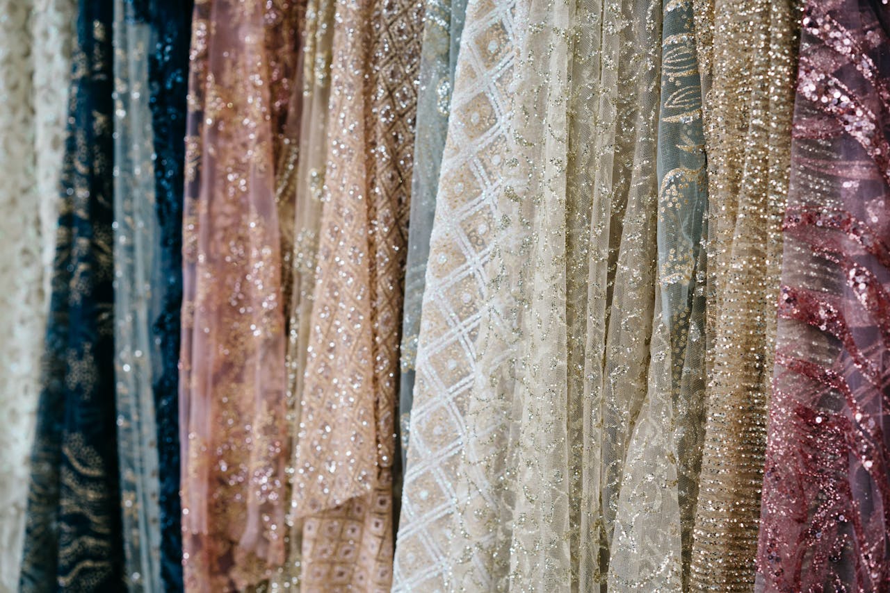 services-01 Close-up view of luxurious fabrics with intricate textures and shimmering details, ideal for fashion and design concepts.
