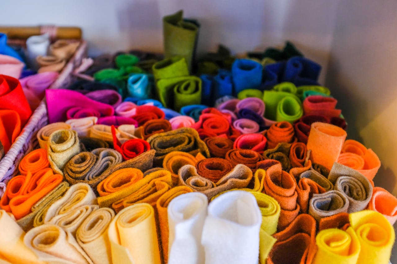 Crafting Captivating Headlines: Your awesome post title goes here A colorful assortment of rolled felt fabric pieces in various hues, perfect for arts and crafts.