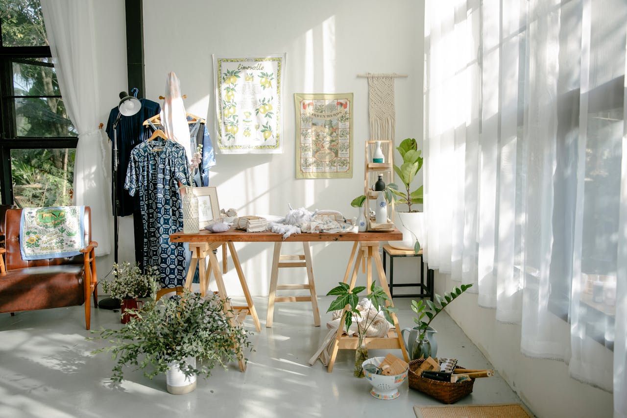 The Art of Drawing Readers In: Your attractive post title goes here Bright and spacious fashion atelier with sunlight streaming in, showcasing handcrafted clothing and decor.